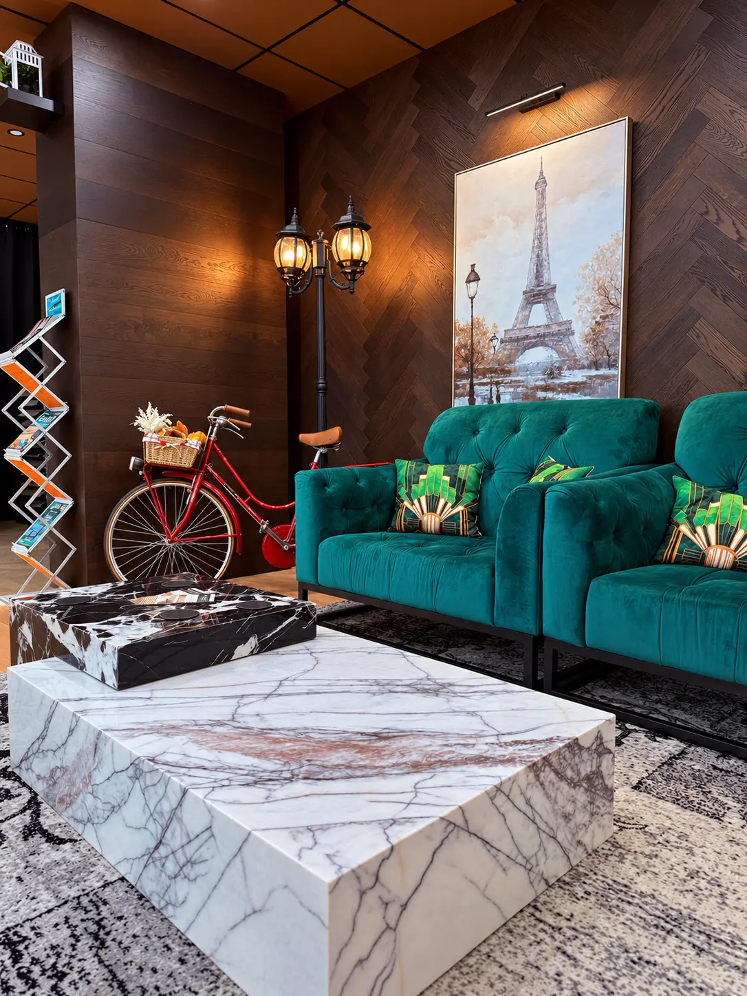 Green velvet sofas and marble table in the showroom lounge